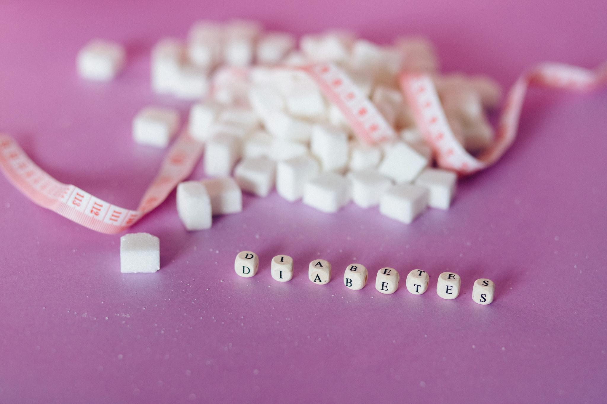 Still life of sugar cubes and diabetes concept with a tape measure, highlighting health awareness.